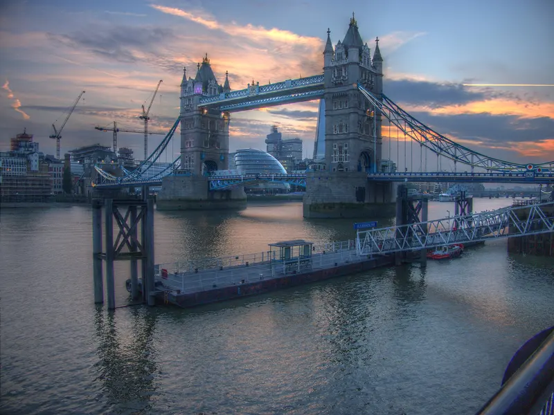 Tower Bridge over the Thames at dusk under an orange and blue sky